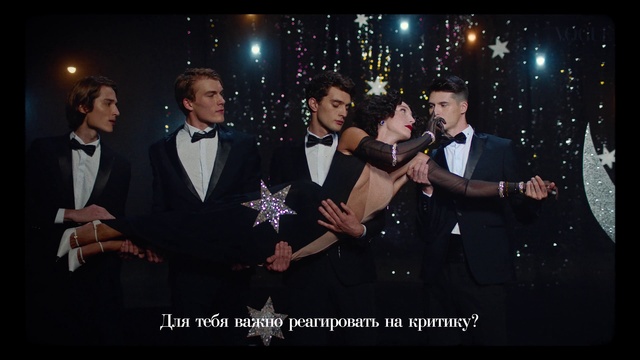 Video Reference: Flash photography, Entertainment, Music, Gesture, Tie, Performing arts, Bow tie, Stage, Formal wear, Event