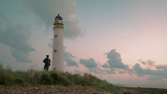Video Reference: Cloud, Sky, Lighthouse, Tower, Natural environment, Plant, Building, Body of water, Beacon, Coastal and oceanic landforms