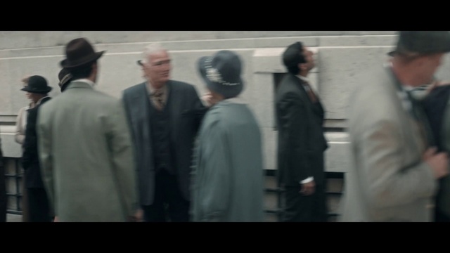 Video Reference: Sleeve, Gesture, Blazer, Suit, Formal wear, Hat, Event, White-collar worker, Font, Dress shirt