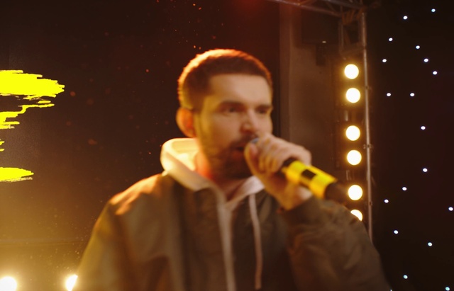 Video Reference: Microphone, Shirt, Musician, Music artist, Public address system, Music, Performing arts, Artist, Entertainment, Audio equipment