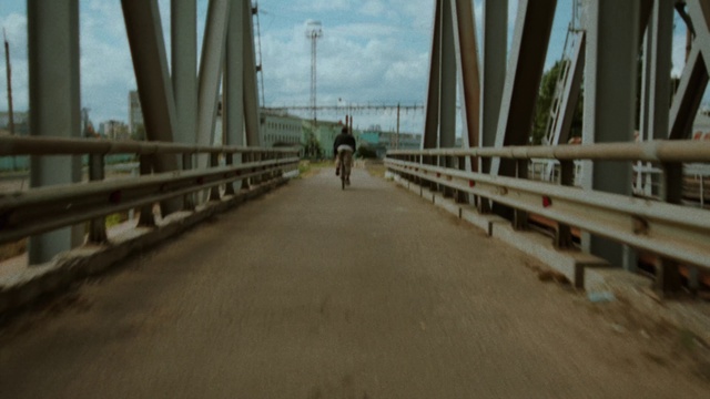 Video Reference: Sky, Bicycle, Road surface, Wood, City, Girder bridge, Asphalt, Road, Bridge, Sidewalk