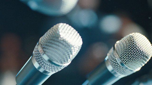 Video Reference: microphones, audio, sound, stage, close-up, wireless, wired, concert, podcast, broadcast, equipment, metal, blurred background, bokeh, performance, speech