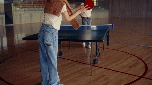 Video Reference: Jeans, Table tennis racket, Sports equipment, Table, Racketlon, Ping pong, Wood, Floor, Racquet sport, Flooring