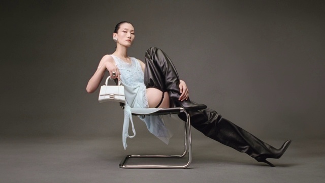 Video Reference: Chair, Flash photography, Comfort, Knee, Eyewear, Fashion design, Human leg, Art, Foot, Event