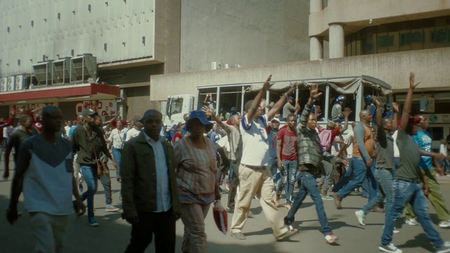 Video Reference: Footwear, Jeans, Trousers, Building, Event, Crowd, Window, City, Pedestrian, Fun