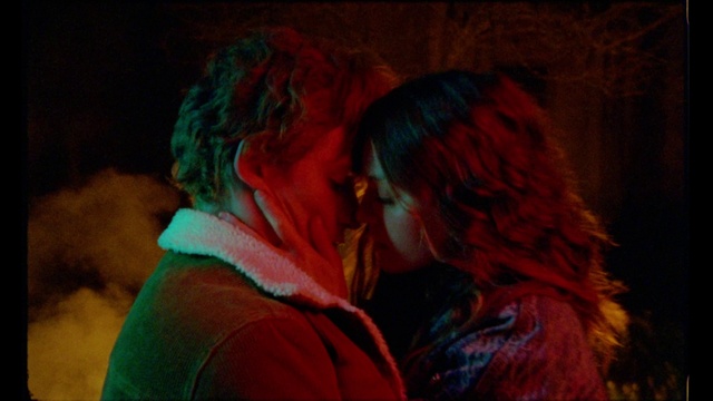 Video Reference: Outerwear, Kiss, Gesture, Entertainment, Magenta, Event, Red hair, Fun, Fur, Electric blue