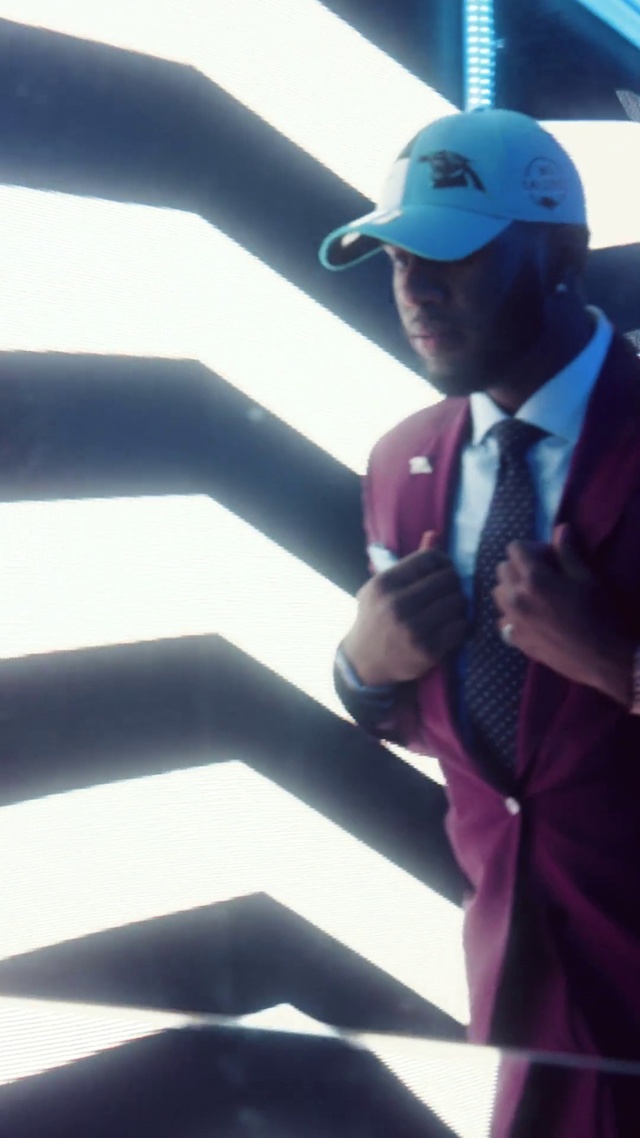 Video Reference: Hand, Arm, Cricket cap, Cap, Standing, Sleeve, Gesture, Baseball cap, Suit, Elbow