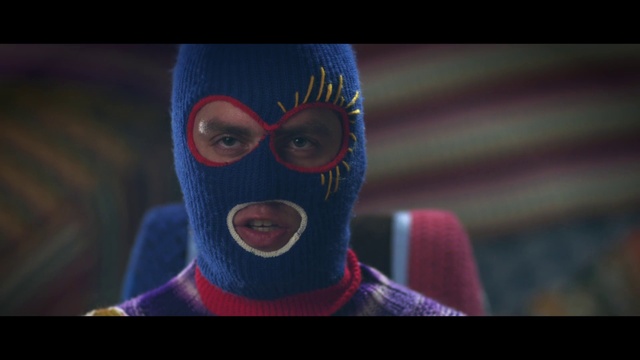 Video Reference: Outerwear, Eyewear, Entertainment, Headgear, Art, Personal protective equipment, Performing arts, Facial hair, Electric blue, Mask