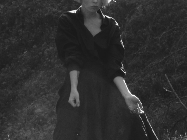 Video Reference: Flash photography, One-piece garment, Sleeve, Standing, Dress, People in nature, Black-and-white, Style, Hat, Eyewear