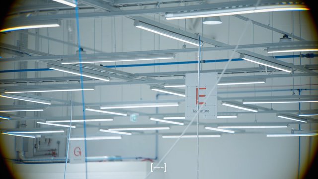 Video Reference: industrial interior, ceiling lights, fluorescent lights, factory, warehouse, metal beams, cables, interior, lighting fixtures, modern facility, high ceiling, indoor, symmetrical, architecture