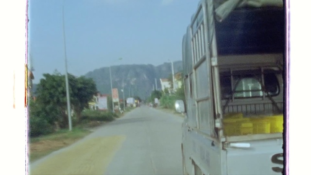 Video Reference: Sky, Bus, Vehicle, Automotive lighting, Automotive tire, Motor vehicle, Asphalt, Plant, Road surface, Mode of transport