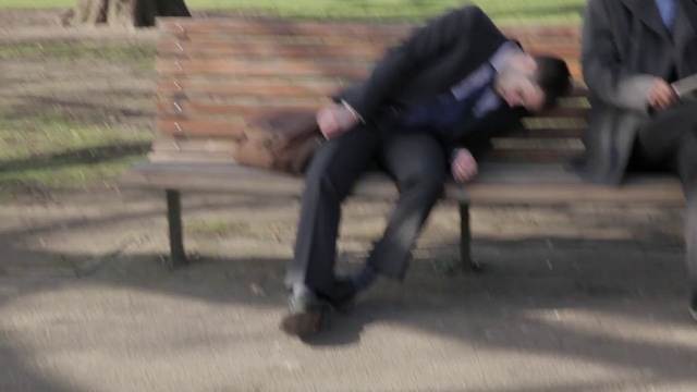 Video Reference: Asphalt, Road surface, Grass, Human leg, Formal wear, Sitting, Soil, Recreation, Knee, Sidewalk