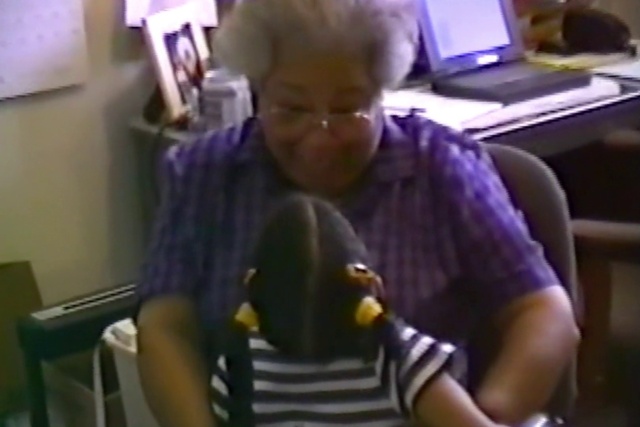 Video Reference: Glasses, Arm, Vision care, Purple, Eyewear, Elbow, Computer keyboard, Sitting, Fun, T-shirt