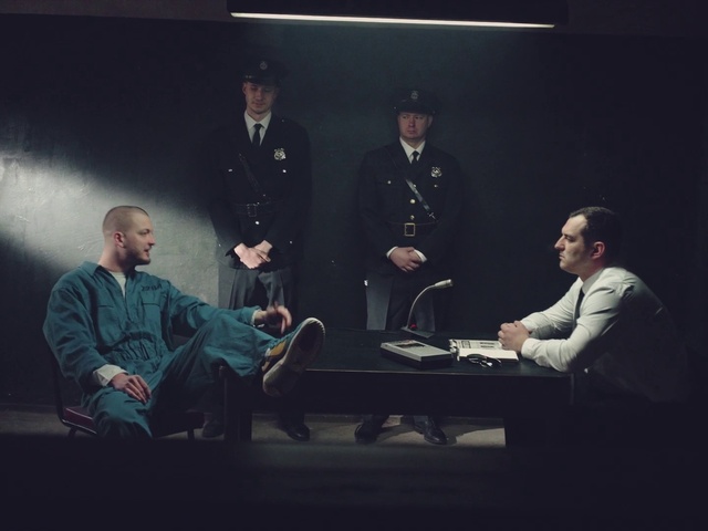Video Reference: Coat, Hat, Entertainment, Performing arts, Table, Chair, Event, Military person, Sitting, Darkness