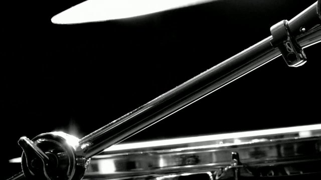 Video Reference: drum kit, cymbal, drum hardware, music, percussion, close-up, black and white, studio lighting, metal, instrument, abstract, dark background