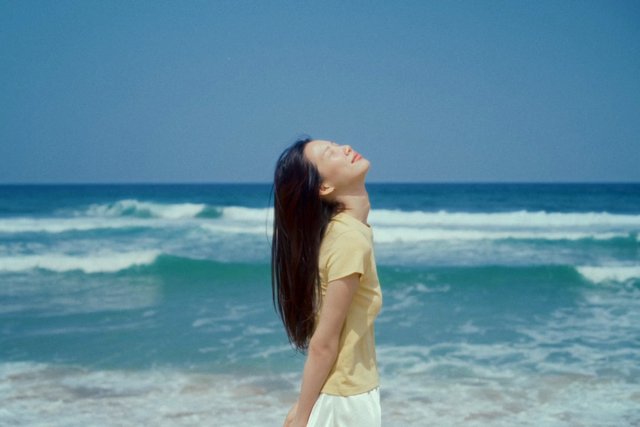 Video Reference: beach, ocean, waves, woman, portrait, outdoors, summer, sea, coastline, relaxation, sunlight, blue sky, profile, nature