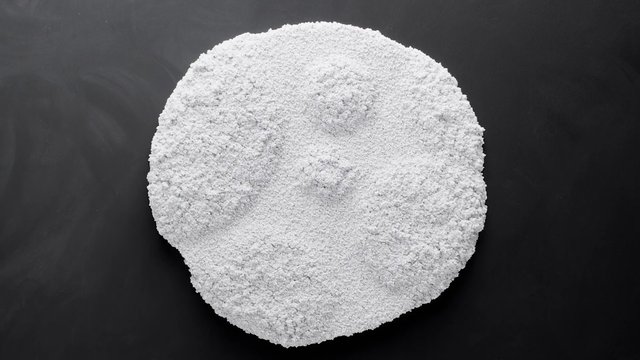 Video Reference: white powder, mound, granules, texture, close-up, abstract, dark background, circular shape, material, pile