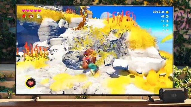 Video Reference: video game, TV screen, 3D graphics, fantasy landscape, rocky terrain, character, game HUD, bright colors, outdoors, blue sky, console game, action game, living room, display