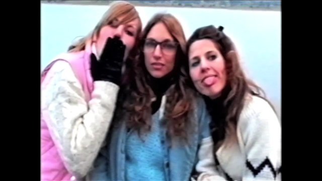 Video Reference: three women, friends, group portrait, outdoor, casual clothing, playful pose, young adults, glasses, winter sweater, closeup, candid, person group, retro video, low resolution