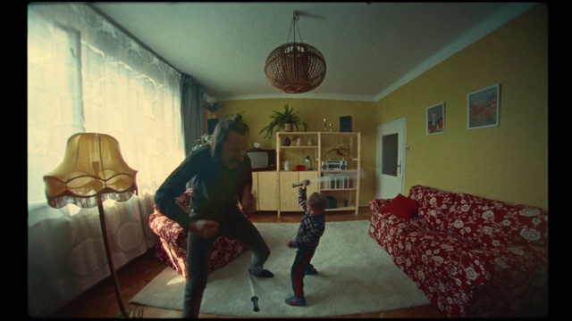 Video Reference: Picture frame, Interior design, Comfort, Couch, Living room, Lamp, Flooring, Floor, Wood, Tints and shades