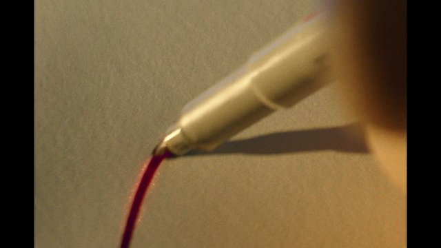 Video Reference: close-up, liquid, red, nozzle, metal, dispensing, macro, surface, equipment, tool, fluid, pouring