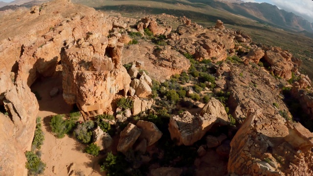 Video Reference: Plant community, Plant, Natural landscape, Bedrock, Sky, Vegetation, Mountain, Terrain, Formation, Outcrop