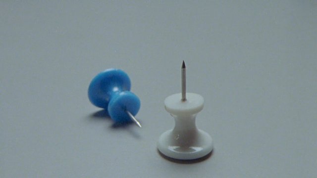 Video Reference: push pin, thumbtack, stationery, office supplies, close-up, minimal, plain background, blue, white, pin, tabletop, still life
