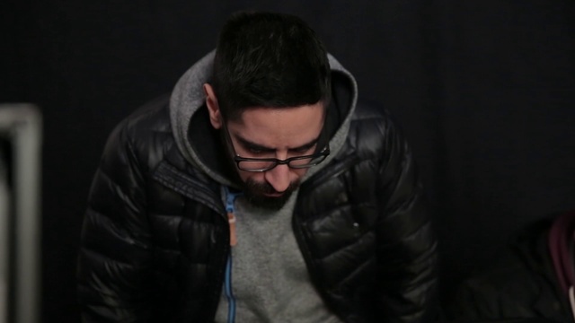 Video Reference: Vision care, Flash photography, Eyewear, Audio equipment, Worried, Facial hair, Darkness, Sitting, Electric blue, Midnight