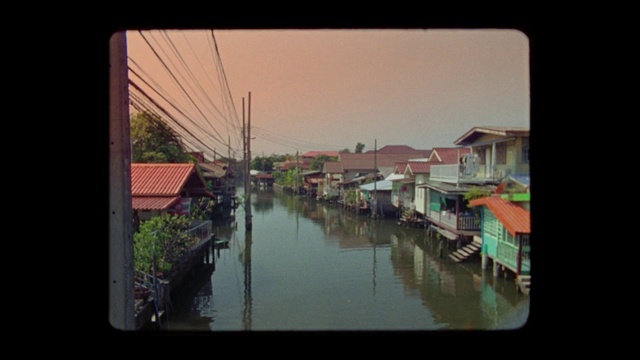 Video Reference: Water, Sky, Building, Window, Rectangle, Plant, Body of water, House, Urban design, Lake