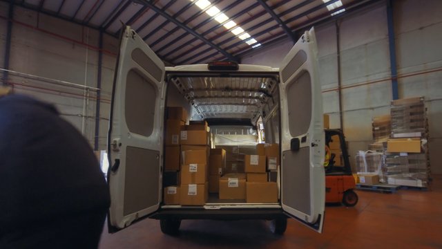 Video Reference: cargo van, warehouse, boxes, shipping, logistics, delivery, freight, storage, forklift, pallet, distribution, transportation, loading, rear view, industrial, inventory