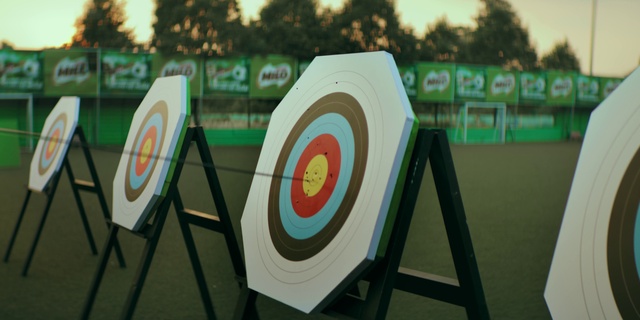 Video Reference: Grass, Archery, Precision sports, Target archery, Tree, Recreation, Arrow, Font, Signage, Graphics