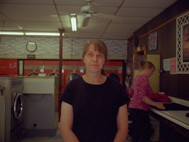 Video Reference: Shirt, Laundry room, Cabinetry, T-shirt, Gas, Computer monitor, Clothes dryer, Picture frame, Desk, Event