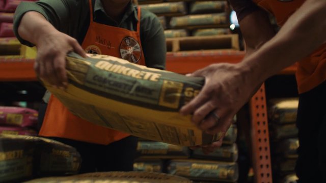 Video Reference: warehouse, workers, handing, sack, bag, stacked goods, storage, inventory, apron, industrial, manual labor, distribution, shelving, package, close-up, indoor