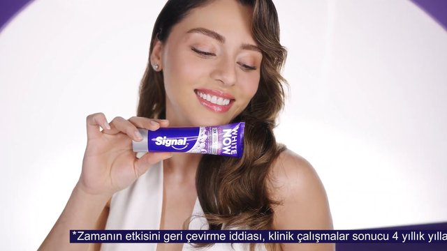 Video Reference: woman, smiling, toothpaste, oral care, product shot, studio, beauty, commercial, white background, close-up, advertisement, brand packaging, model, dental hygiene