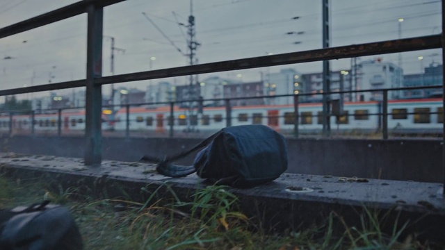 Video Reference: Sky, Automotive tire, Mode of transport, Grey, Plant, Bin bag, Rolling, Asphalt, Window, Railway