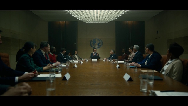 Video Reference: Table, Conference room table, Coat, Chair, Suit, Desk, Drinking water, Event, Conference hall, Public speaking