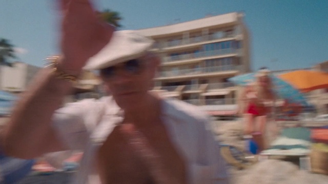 Video Reference: Sky, Hat, Gesture, Travel, Headgear, Building, Eyewear, People on beach, Barechested, Leisure