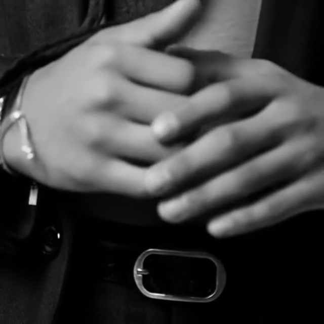 Video Reference: White, Black, Human body, Mobile phone, Neck, Sleeve, Finger, Gesture, Flash photography, Gadget