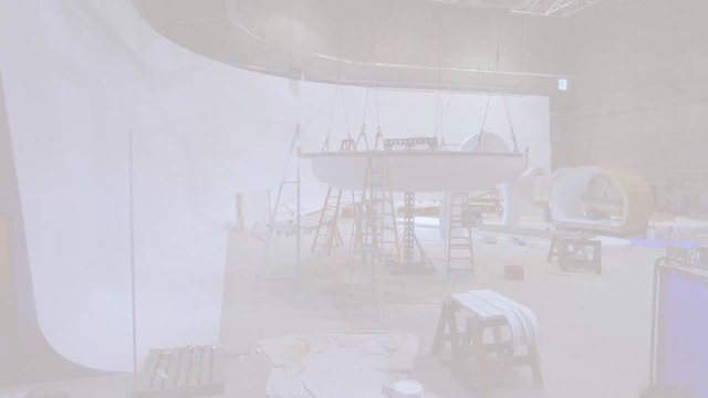 Video Reference: studio, stage, set design, rigging, ladders, platform, construction, interior, lighting, overexposed, props, backdrop, workshop, production