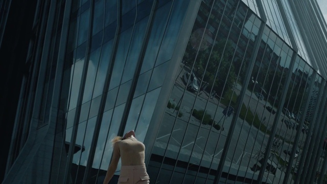 Video Reference: Building, Grey, Tower block, Facade, City, Glass, Commercial building, Condominium, Electric blue, Headquarters