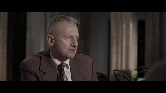 Video Reference: Flash photography, Tie, Suit, Spokesperson, Blazer, Formal wear, Event, Official, White-collar worker, Wrinkle