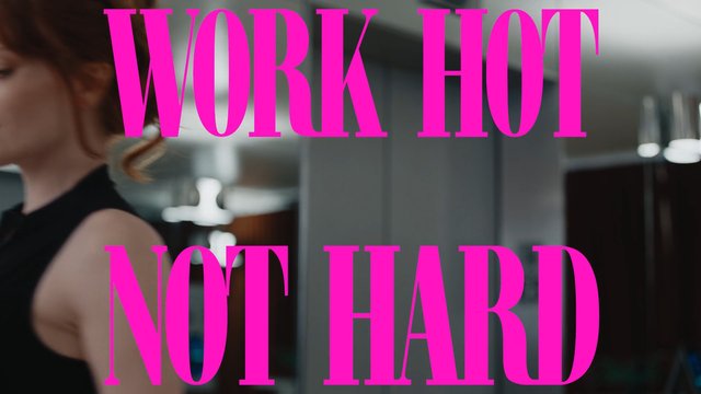 Video Reference: woman, indoor, blurred, text overlay, pink text, motivational quote, office, workplace, poster, typography, fashion, modern, cropped subject, motion blur