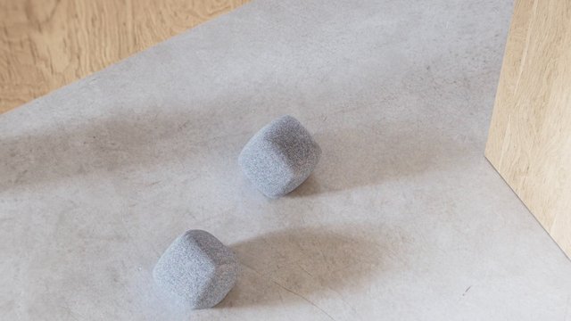 Video Reference: foam cubes, gray objects, abstract, indoor, tabletop, wood panels, minimal, still life, soft material, close-up, texture, geometry
