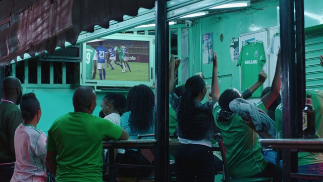 Video Reference: Clothing, Green, Window, Standing, Mode of transport, Motor vehicle, T-shirt, Leisure, Shorts, Technology