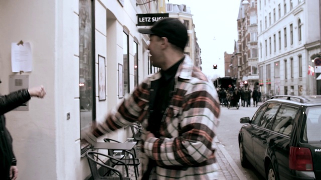 Video Reference: Car, Vehicle, Tire, Fashion, Street fashion, Automotive lighting, Sleeve, Standing, Building, Tartan