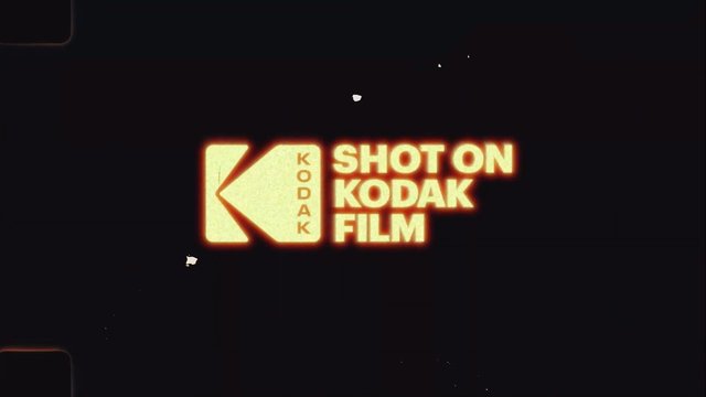 Video Reference: kodak, film, logo, text, branding, retro, vintage, dark background, glow, title card