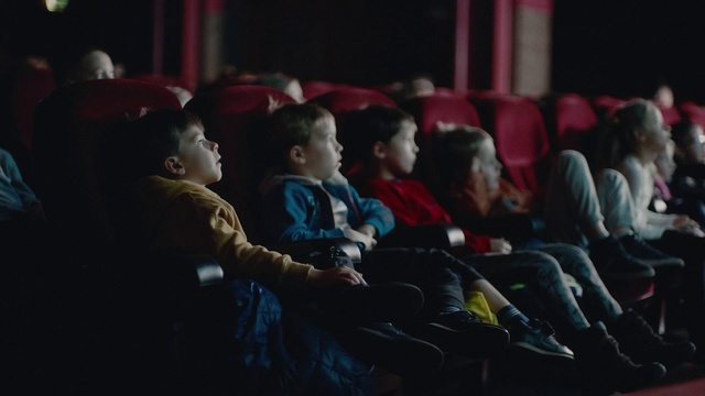 Video Reference: T-shirt, Event, Crowd, Darkness, Recreation, Competition event, Fun, Chair, Sitting, Audience