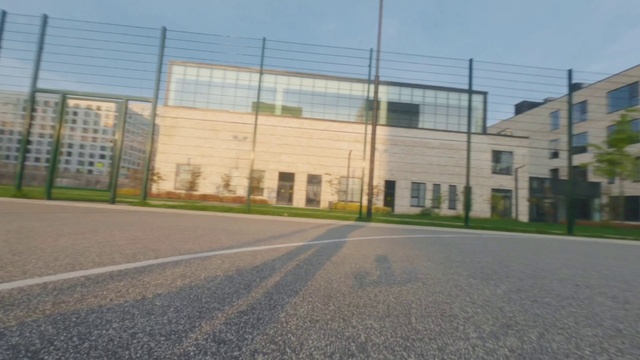 Video Reference: Sky, Building, Road surface, Asphalt, Land lot, Window, Grass, Tar, Real estate, City