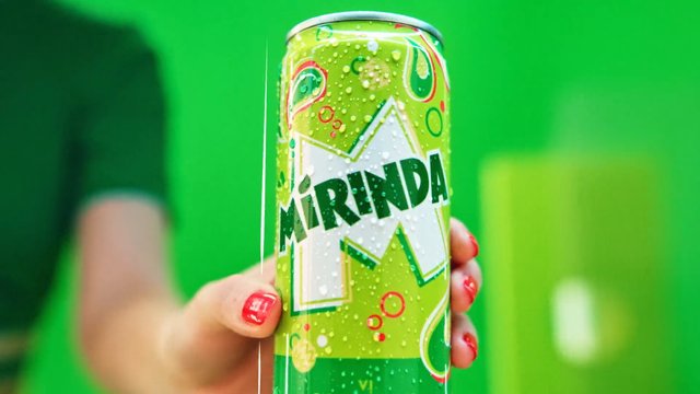 Video Reference: soda, soft drink, can, beverage, close-up, hand, green background, cold drink, carbonated, product shot, refreshment, drink can