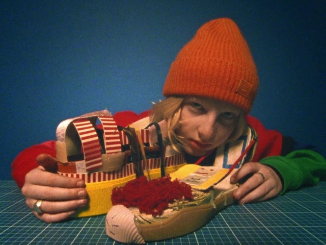 Video Reference: Hand, Table, Tableware, Orange, Toy, Musical instrument, Cuisine, Cap, Recreation, Folk instrument